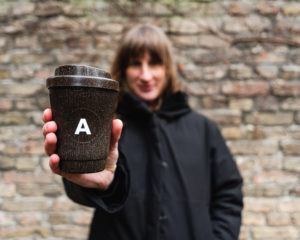 Person hält den Kaffeeform Alphabet Weducer mit dem Buchstaben A aufgedruckt vor einer